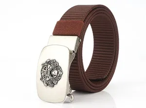 Detail of men's brown nylon belt featuring a silver lion head embossed automatic buckle