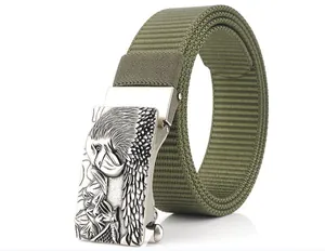 Close-up of military green nylon belt with silver metal eagle head embossed buckle