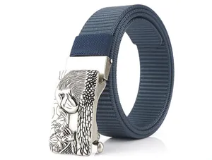 Close-up of navy nylon belt with embossed silver eagle buckle and woven texture