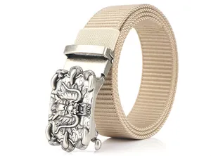 Detail of silver automatic buckle with embossed dragon pattern on khaki nylon belt