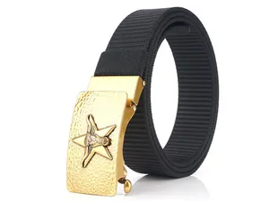 Detail of black nylon belt with textured golden buckle featuring relief star and bullhead