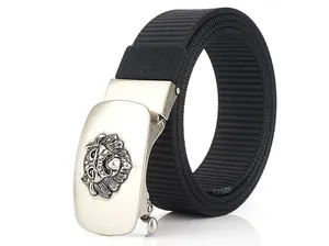 Detail of nylon belt with automatic buckle featuring a lion head relief pattern