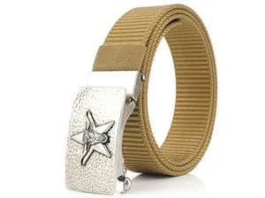 Macro detail of men's nylon belt with star and bull head engraved silver metal buckle