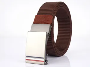 Detailed macro of brushed metal buckle and brown woven nylon strap with reflection