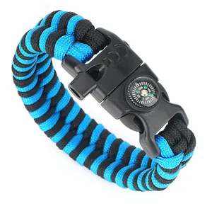 Detail of blue and black paracord survival bracelet with built-in compass and whistle buckle