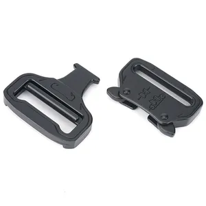 Macro view of matte black 39mm Cobra tactical quick release buckle showing metal texture