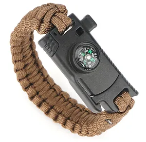 Close-up of brown survival paracord bracelet with compass and black plastic buckle