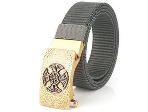 Detailed close-up of grey nylon strap with a textured gold Celtic cross metal buckle