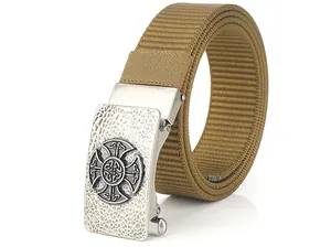 Detailed close-up of khaki nylon belt with textured metal buckle and Celtic cross relief