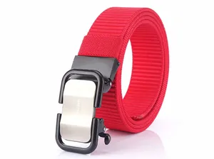 Detail of red nylon belt with silver brushed metal automatic buckle featuring TUSHI logo