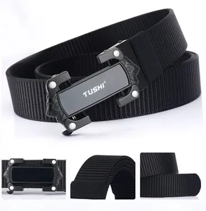 Macro detail of high-density black nylon belt with matte metal buckle and lion head relief
