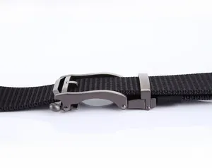 Detail of adjustable metal automatic buckle on black nylon woven tactical belt strap