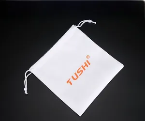 White cotton drawstring dust bag with orange TUSHI logo for premium men leather belts