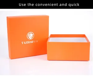 Close-up of orange gift box with lid featuring a lion logo and white interior lining
