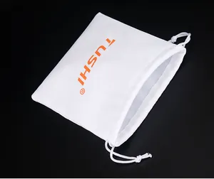 Close-up of white TUSHI drawstring dust bag for belt storage on black background