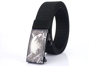 Detail of black nylon canvas belt with a metallic eagle head embossed buckle buckle