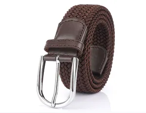 Detailed view of dark brown woven elastic belt with polished silver buckle and leather trim