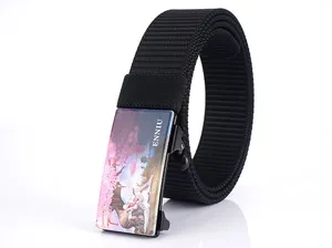 Detail of black nylon belt with art-printed automatic buckle showing cherry blossom graphics