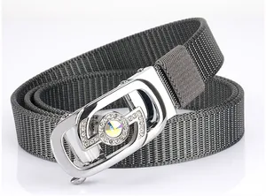 Detailed close-up of dark grey nylon braided belt with sparkling rhinestone metal buckle