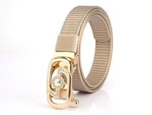 Macro detail of khaki woven nylon belt strap with gold hollow buckle and diamond inlay
