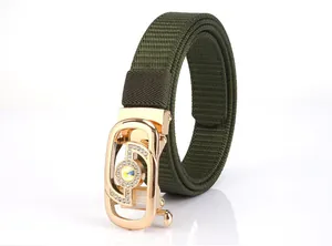 Close-up of military green nylon woven belt featuring a rhinestone-encrusted gold buckle