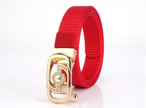 Close-up of a red woven belt with a gold rhinestone buckle and central gemstone