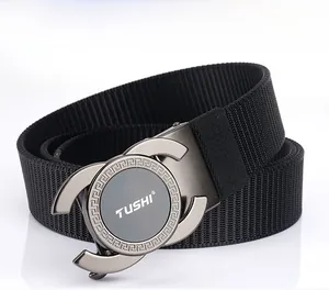 Detail of black nylon woven belt with a brushed alloy buckle featuring greek patterns