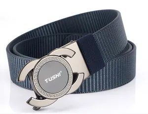Macro detail of navy nylon belt with gun-grey alloy buckle and Greek pattern