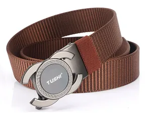 Detail of a brown nylon belt with a grey alloy automatic buckle and Greek key patterns