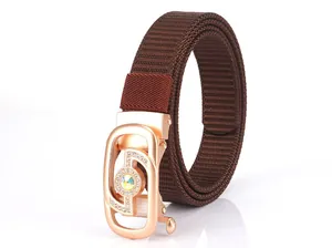Detail of dark brown woven nylon belt with rose gold automatic buckle and gemstone