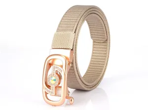 Detail of khaki woven nylon belt with rose gold rhinestone-encrusted buckle and gemstone
