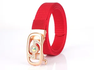 Detail of red woven nylon belt with rose gold rhinestone buckle and crystal centerpiece