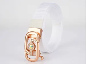 Detail of white nylon woven belt featuring a rose gold buckle with large crystal