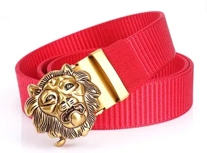 Close-up of golden embossed lion head buckle on red nylon canvas belt for men