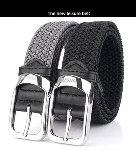 Close-up of woven elastic belts with silver metal pin buckles and leather accents