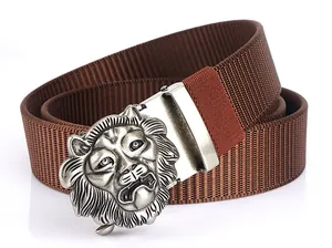 Detailed macro view of brown nylon tactical belt with embossed silver lion head buckle