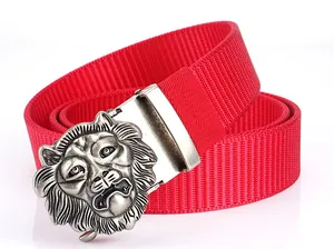 Detail of red nylon tactical belt featuring a 3D embossed silver lion head buckle
