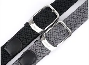 Close-up of woven stretch belts with polished metal pin buckles and leather end tips