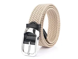 Macro detail of beige braided elastic belt showing silver pin buckle and TUSHI logo