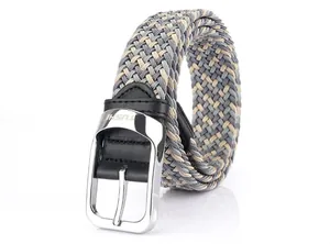 Macro detail of elastic braided belt with silver pin buckle and gray weave pattern