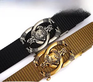 Detail of military tactical belt featuring a heavy metal buckle with an embossed wolf head
