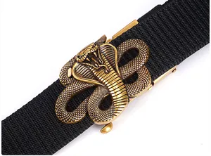 Detail of golden cobra buckle on durable black tactical nylon belt for outdoor wear