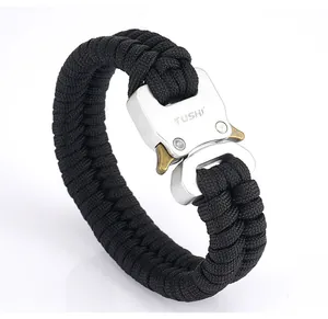 Detail of black paracord bracelet featuring a textured silver buckle and secure clasp