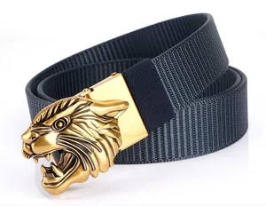 Close-up of golden tiger head buckle on navy blue woven nylon tactical belt for men