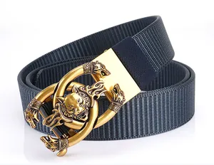 Close-up of golden metal buckle with wolf head reliefs on navy nylon canvas belt
