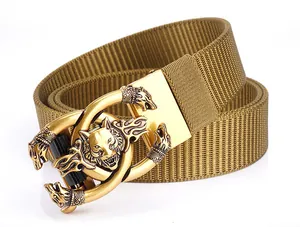 Detail of khaki nylon web belt showing textured canvas and 3D wolf head buckle