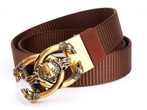 Close-up of brown nylon belt featuring a golden metallic buckle with a 3D wolf head design