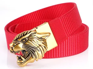 Detail of red tactical nylon belt featuring a gold tiger head metal relief buckle