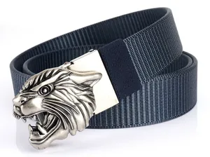 Close-up of a silver tiger head buckle on a navy blue woven nylon tactical belt