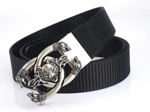 Macro detail of tactical nylon belt featuring a silver wolf head metal relief buckle
